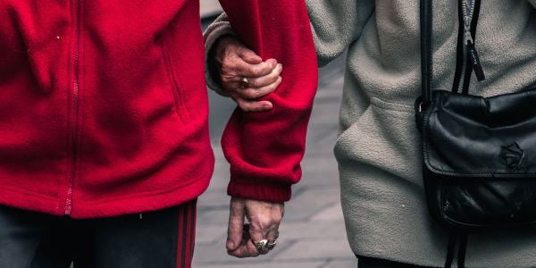 senior couple walking arm in arm